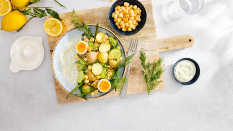 Potato salad with egg, green asparagus and popped Cheddar