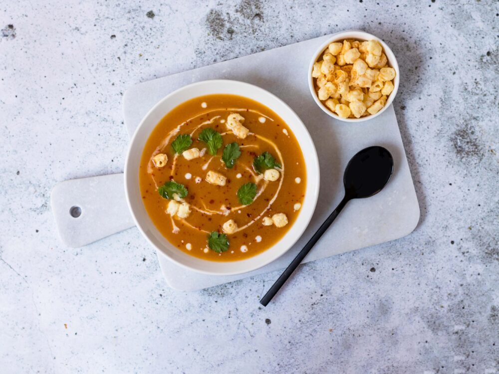 This slightly spicy Thai pumpkin soup gets a nice bite by adding the popped Chesepop Gouda cheese balls